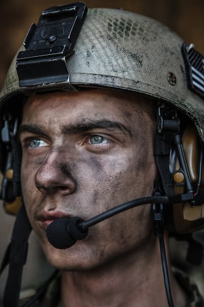 A detailed close-up shot of a US soldier participating in the training exercise. The soldier is wearing full combat gear and is focused on a simulated combat situation.
