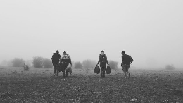 A black and white photograph showing Theodore Roosevelt leading the Rough Riders up San Juan Hill, with soldiers charging amidst gunfire and smoke.