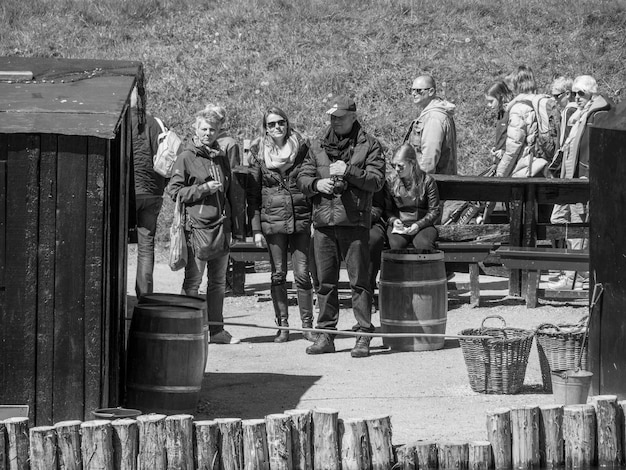 A black and white photograph of soldiers from the American Civil War era eating hardtack. The image should convey the conditions and challenges of consuming this ration.