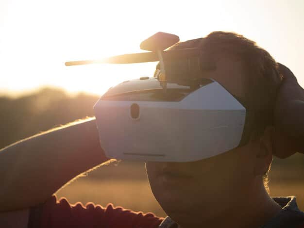 A soldier or military figure in profile, demonstrating the wear and potential field of view of a panoramic night vision goggle system, highlighting its multi-lens design.