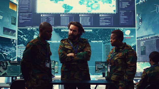 A diverse group of defense industry professionals collaborating around a digital projection of a missile system, emphasizing synergistic partnerships between large and small enterprises.
