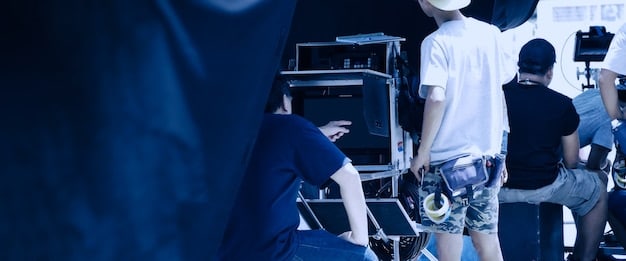 A recruitment fair booth for a defense company, featuring interactive displays and recruiters engaging with enthusiastic young professionals, highlighting technology and innovation.