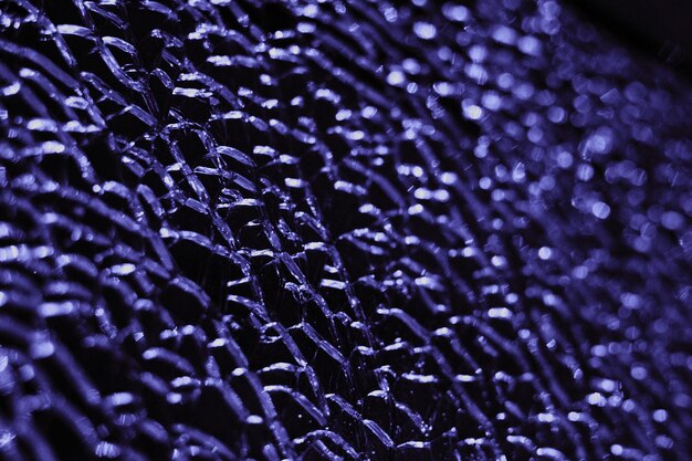 A detailed, close-up shot of a futuristic composite material, perhaps showing tightly woven fibers or a textured surface, symbolizing advanced material science and its role in defense.