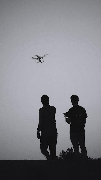 A depiction of a US Army soldier operating a mobile counter-drone jammer system during a field exercise, with a drone silhouette in the background.