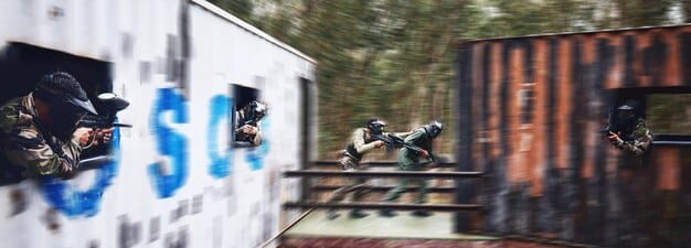 US Army soldiers participating in an urban warfare training exercise, navigating through a simulated building with realistic debris and obstacles. They are equipped with training gear and engaging simulated threats.