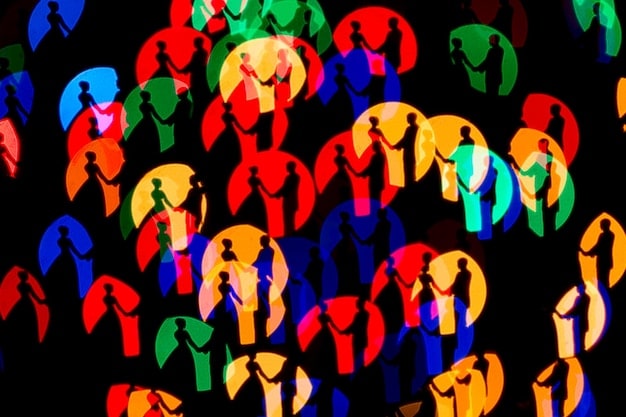 A diverse group of people engaged in a community dialogue, with abstract digital lines radiating from them, symbolizing the spread of positive counter-narratives and community resilience.