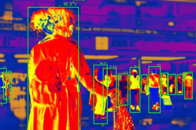 A close-up view of a thermal imaging display, showing a heat signature of a person in a dark environment. The image is highly detailed, with clear distinctions between different heat sources. Text overlay indicates temperature readings and sensor specifications. It illustrates the advanced resolution and sensitivity of modern thermal imaging technology, highlighting capabilities like target identification in low visibility conditions. What are the Latest Advancements in Night Vision Technology for Special Operations Forces?