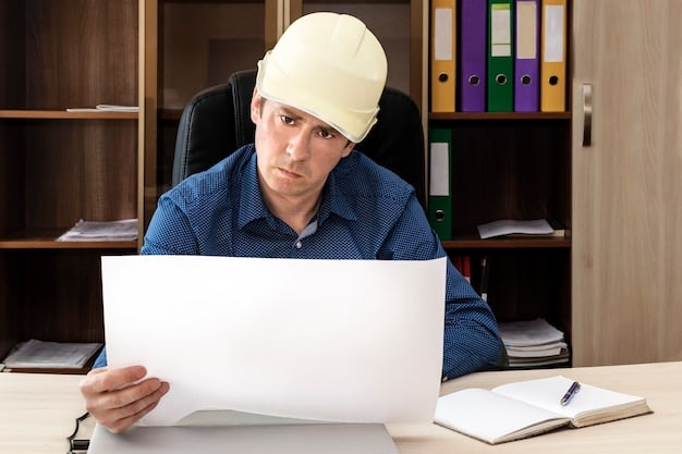 A worried contractor sitting at a desk piled high with paperwork, with a framed picture of the American flag visible in the background. This visual emphasizes the stress and stakes involved in Defense Contract Audits: How to Prepare and Avoid Penalties in the Current Fiscal Year.