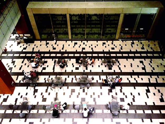 An aerial view of a conference hall filled with people, booths, and presentations, showcasing the scale and potential of the US Defense Industry Conferences: 5 Must-Attend Events for Networking and Business Development.